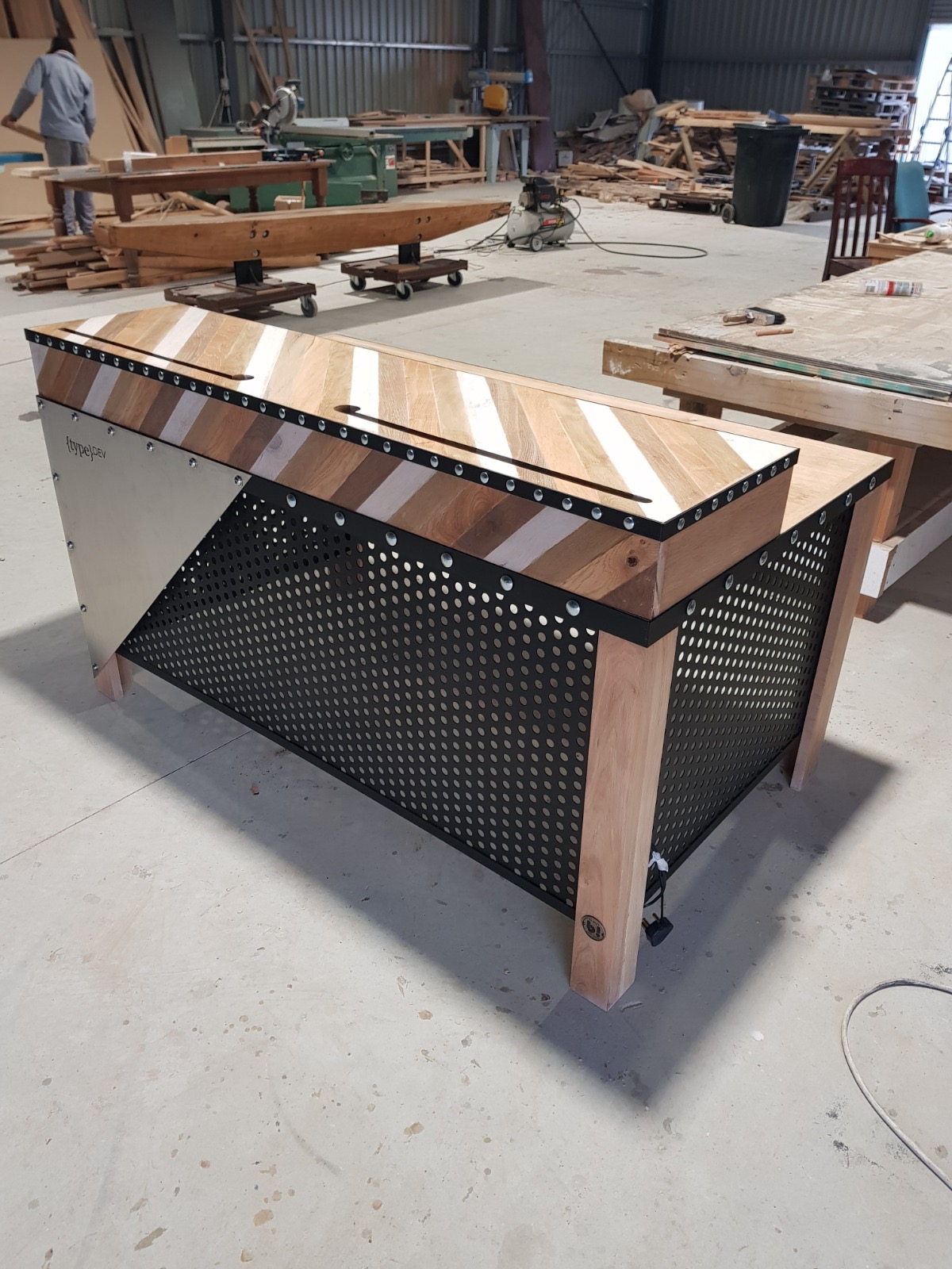 Custom typeDEV corporate desk in oak with black perforated steel screens by Brandt Möbel Kreatif