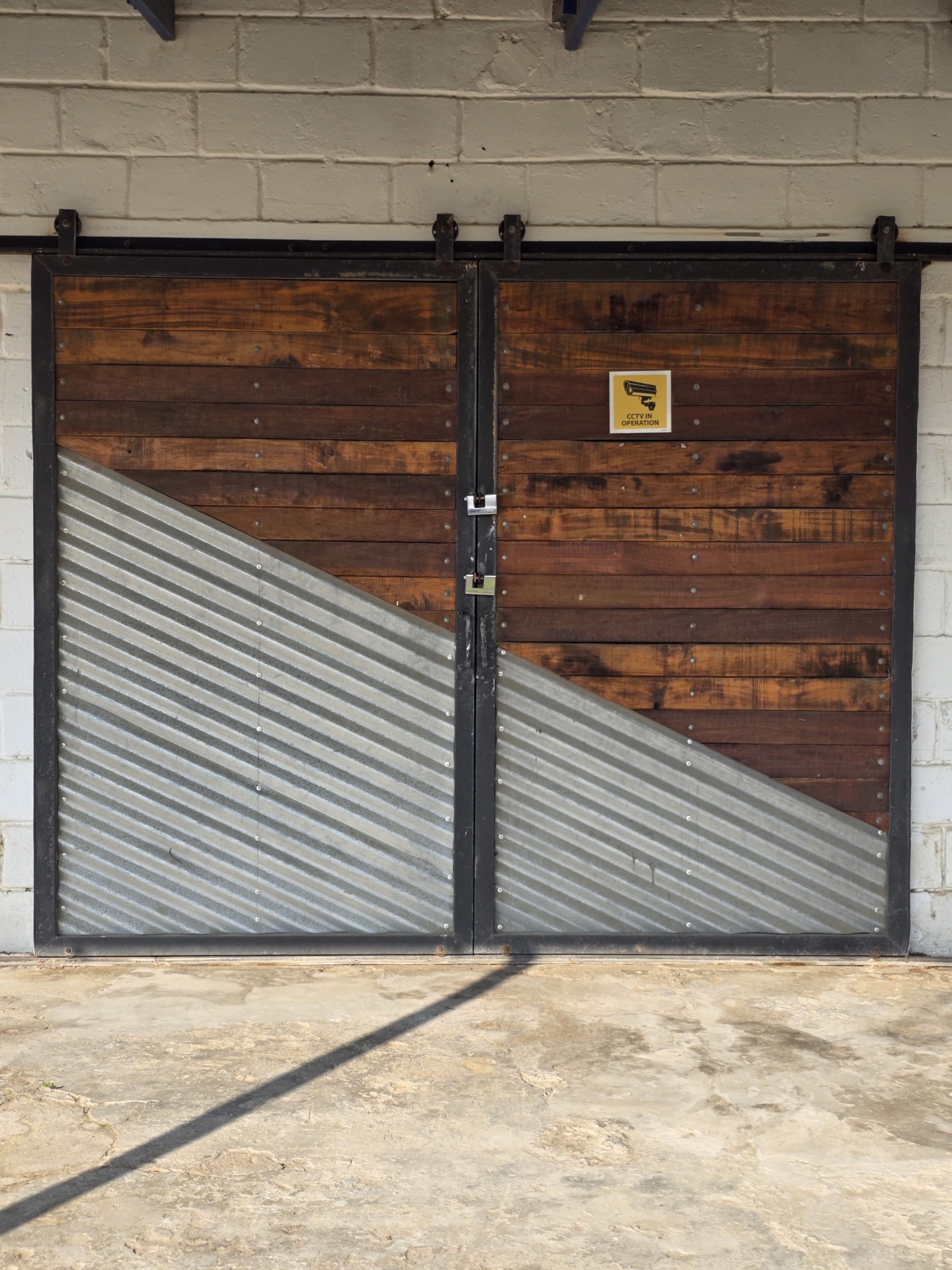 Industrial sliding barn doors in reclaimed timber and corrugated steel by Brandt Möbel Kreatif